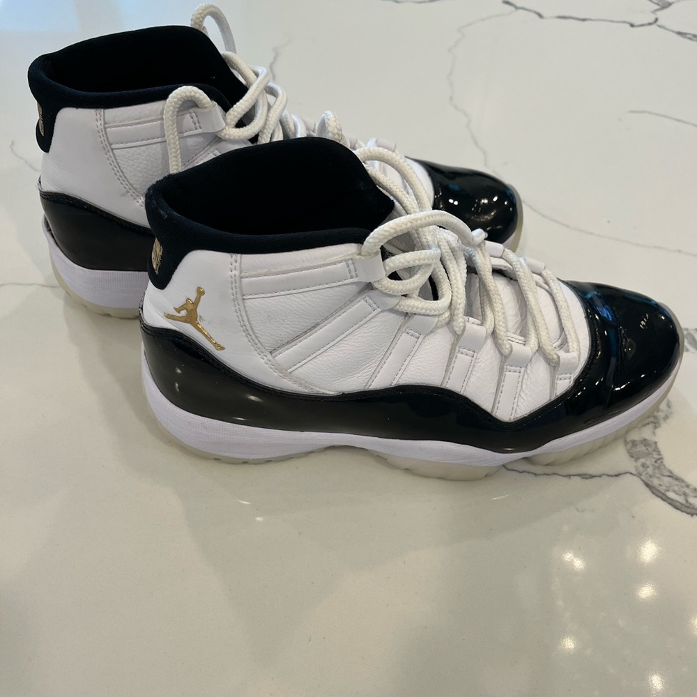 White and Black High-Top Jordans Sneakers with Gold Logo